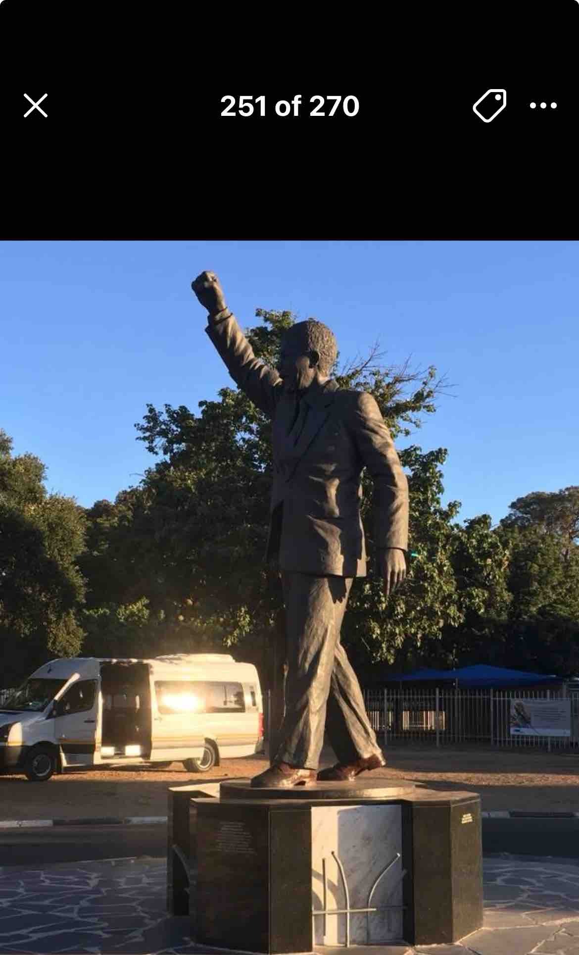 Identify the person depicted in this statue and explain the significance of the pose and location.